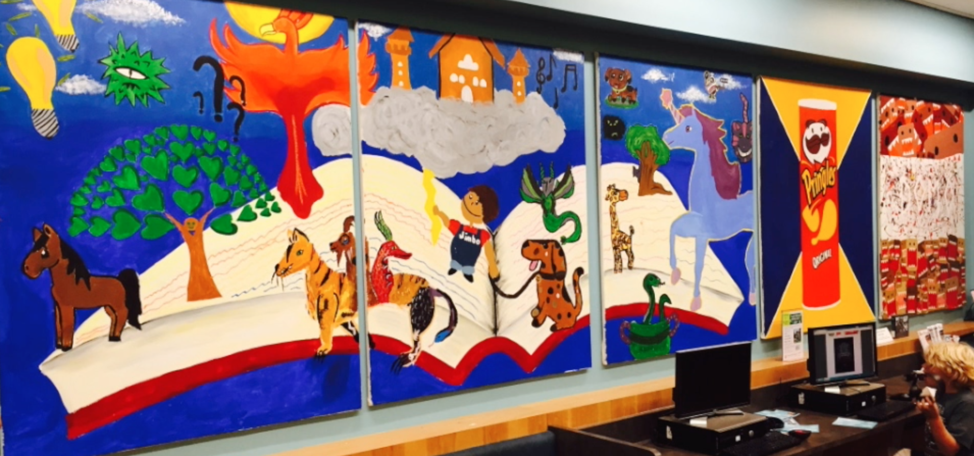 Picture of three large paintings created by Rodrigo Carapia & teens in south Madison