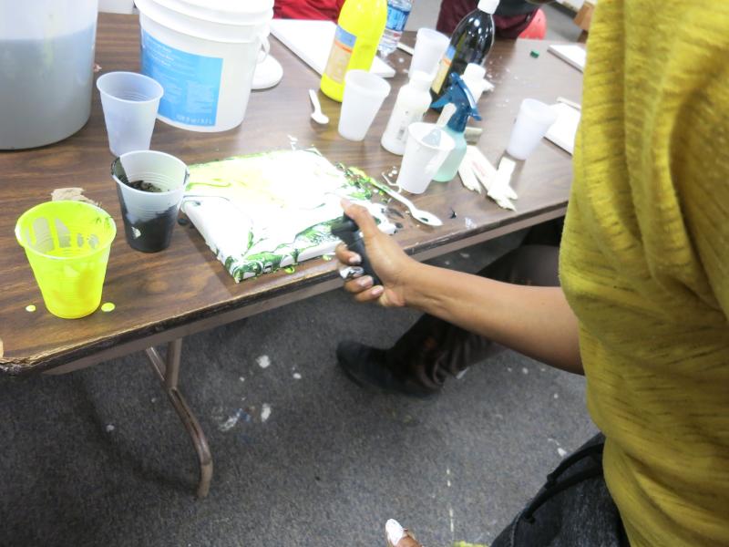 picture of teens creating drip paintings during Air It Out semester of art