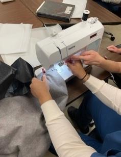 Jail student learning to sew.