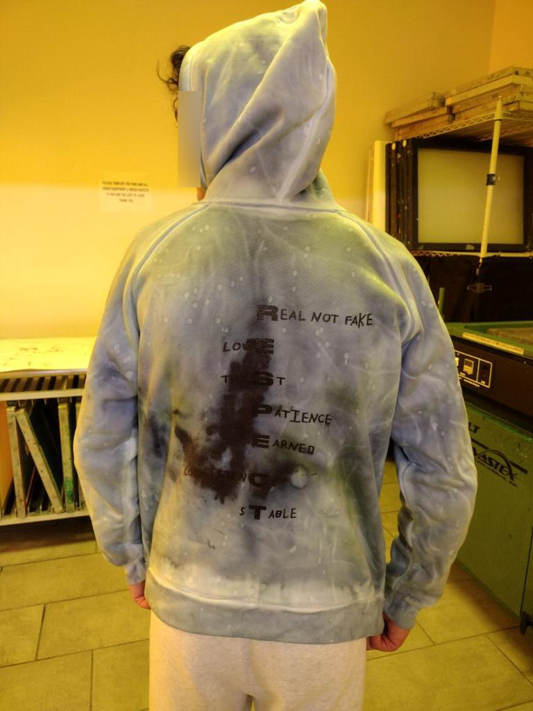 Student modeling a hoodie with logo for "RESPECt" personal brand