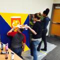 Picture of teens painting a Pringles can mural.