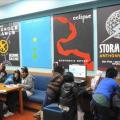 Picture of teens using library with murals in background