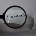 picture of the word "research" through a magnifying glass